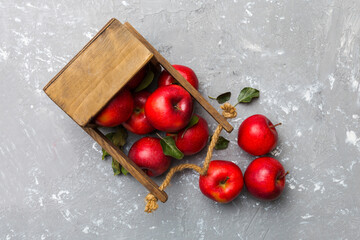 Many red apples on cement background, top view. Autumn pattern with fresh apple above view