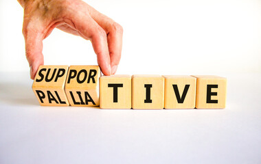 Palliative or supportive therapy symbol. Doctor turns cubes, changes words palliative to supportive. Beautiful white background, copy space. Medical, palliative or supportive therapy concept. - obrazy, fototapety, plakaty