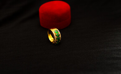 Valuable jewellery golden ring with heart-shaped red color box isolated on background with copy space. 