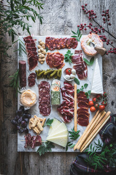 European Charcuterie Board of fine cheese and cured meats, served on a rustic tray