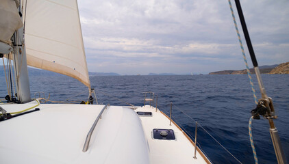 view from the bow of the catamaran yacht cruising by sea, Greece, Europe