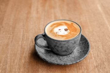 cup of coffee on wooden table