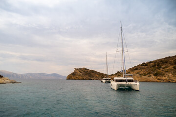 Catamaran sail Yacht anchored on deep blue sea water