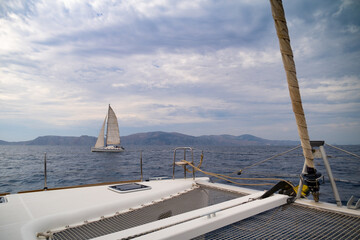 Fototapeta na wymiar view from the bow of the catamaran yacht cruising by sea, Greece, Europe