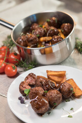 Stewed meatballs in cheese sauce
