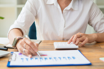 Close up view of bookkeeper or financial inspector hands making report, calculating or checking...