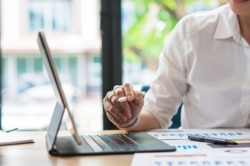 Smiling middle-aged female employee talk brainstorm with female colleague at office briefing in boardroom, happy diverse coworkers have fun laugh cooperating discussing ideas at meeting