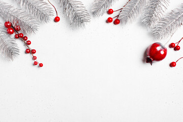 White Christmas background with Christmas tree branches and red berries