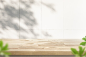 Wood table top on blur home wall background.