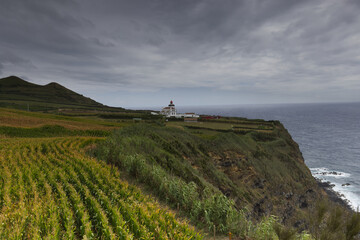 Fototapeta na wymiar The coast with the lighthouse of Ponta da Ferraria, Sao Miguel island, Azores