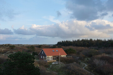 Fototapeta na wymiar vacation house in the dunes of the Wadden isle Vlieland at the end of a sunny day in autumn