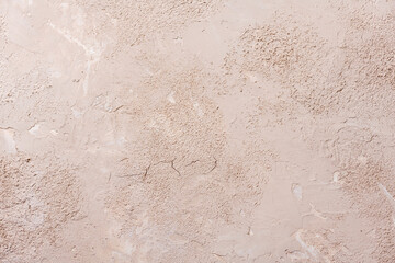 Grunge background with old stucco wall texture of beige color.