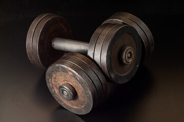 Obraz na płótnie Canvas rusty dumbbell. gym fitness concept dumbbell on dark background
