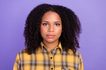 Photo of serious young dark skin woman wear plaid shirt casual calm face isolated on purple color background