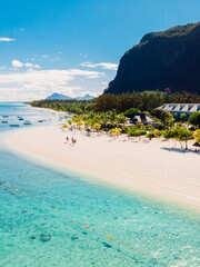 Luxury beach with Le morne mountain in Mauritius. Beach with palms and transparent ocean. Aerial view
