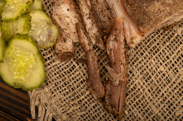 Thinly sliced homemade lard with pepper and chopped pickles close-up, selective focus.