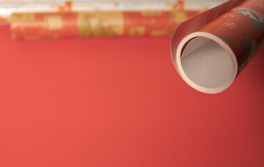 Colored paper for wrapping gifts. close-up, on a red background. Copy space