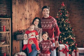 Portrait of attractive cheerful family embracing spending winter time advent eve at decorated loft industrial interior style indoors