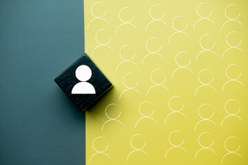 Black wooden block with people icon and many icons, representing a group of people. Employment choice concept..