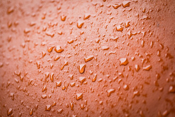 Water drops on brown color leather material, side view