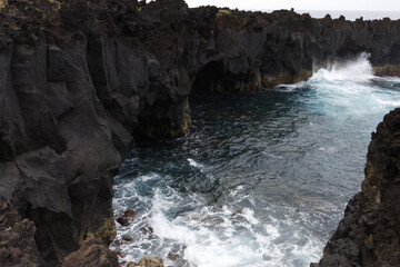 Volcanic lava formations on the coast at Ferraria, Sao Miguel island, Azores