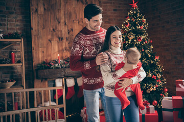 Photo of young family happy positive smile hold newborn child winter holiday decoration x-mas celebration indoors