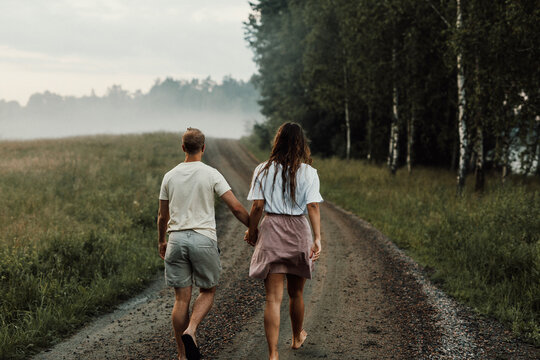 Couple walking on dirt road