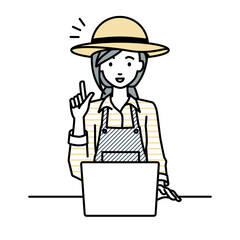 デスクで座ってPCを開いて何かひらめいた農家の女性