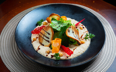 Salad with vegetables and bread on black background