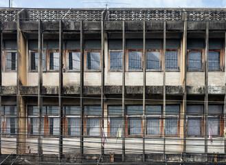 Row of aged commercial building with window in suburban