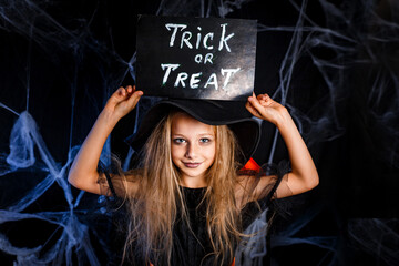 Little girl in Halloween costume trick or treating. Halloween decoration