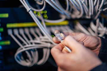 Technician holding ethernet cable. Setting up the connection. - obrazy, fototapety, plakaty