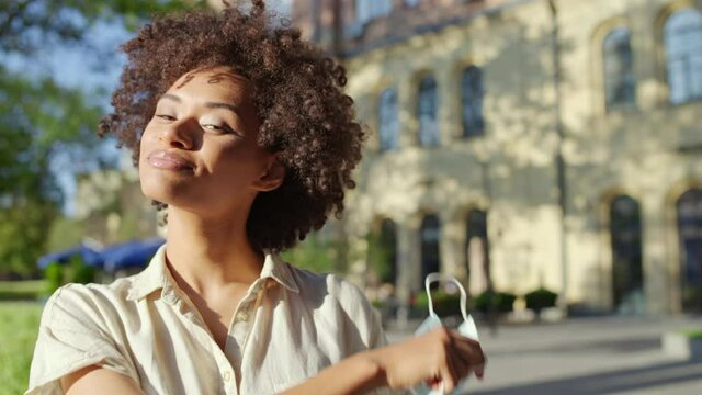 Healthy And Happy African American Woman Taking Off Face Mask, Breathing Freely