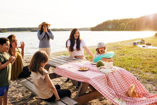 Family having picnic at lake