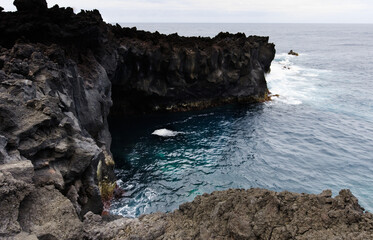 Volcanic lava formations on the coast at Ferraria, Sao Miguel island, Azores