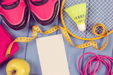 Sport shoes with different accessories for fitness and fresh apple. Healthy sporty lifestyles