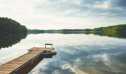 Wooden pier at a calm lake, Poland.