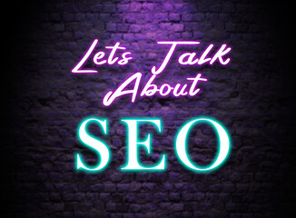 Lets talk About SEO  Neon Text sign. Glowing Bright lettering on dark brick wall background. Pink and Blue Neon effect. Search engine Optimization discussion Concept 