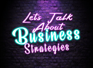 Let's talk About business Strategies  Neon Text sign. Glowing Bright lettering on dark brick wall background. Pink and Blue Neon effect. Business strategy discussion Concept 