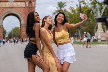Fashionable women taking selfie in city