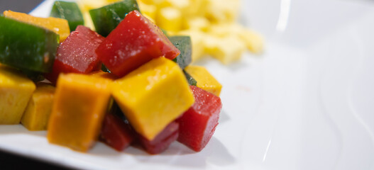Plate of fresh diced fruit paste and cheese cubes