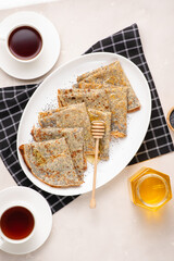Thin crepes with poppy seeds.