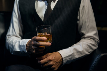 Businessmen in suits drinking whiskey