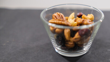 Small class of fresh nuts above black surface