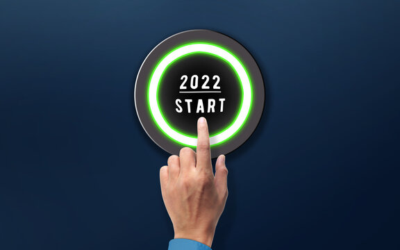 Hand Press Start button of 2022 New Year. Happy new Year Concept Idea. Human Finger  pressing 2022 Start button 