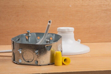 an octagon steel electrical wiring junction box with  wire nuts and a white utility light socket in...