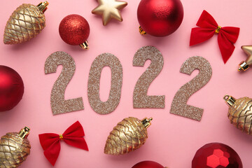 Christmas background with fir trees, fir cones and Christmas decorations and numerals 2022. New...