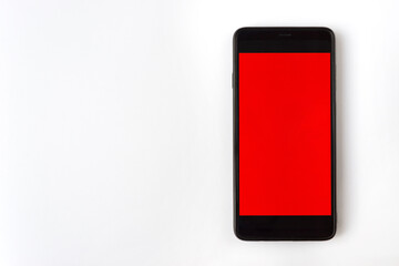 Smartphone with the red display on white background. Mock up, copy space.