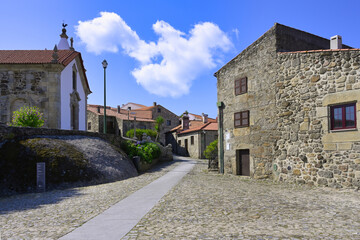 Fototapeta na wymiar Narrow and shadowed street, Linhares de Beira, Historic village around the Serra da Estrela, Castelo Branco district, Beira, Portugal