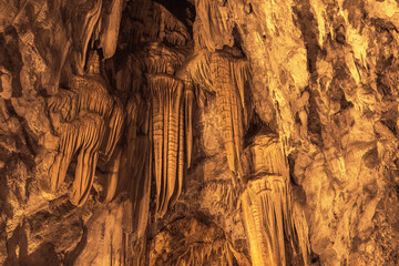 Stalactite formations hanging from the ceiling of the Dim Cave.